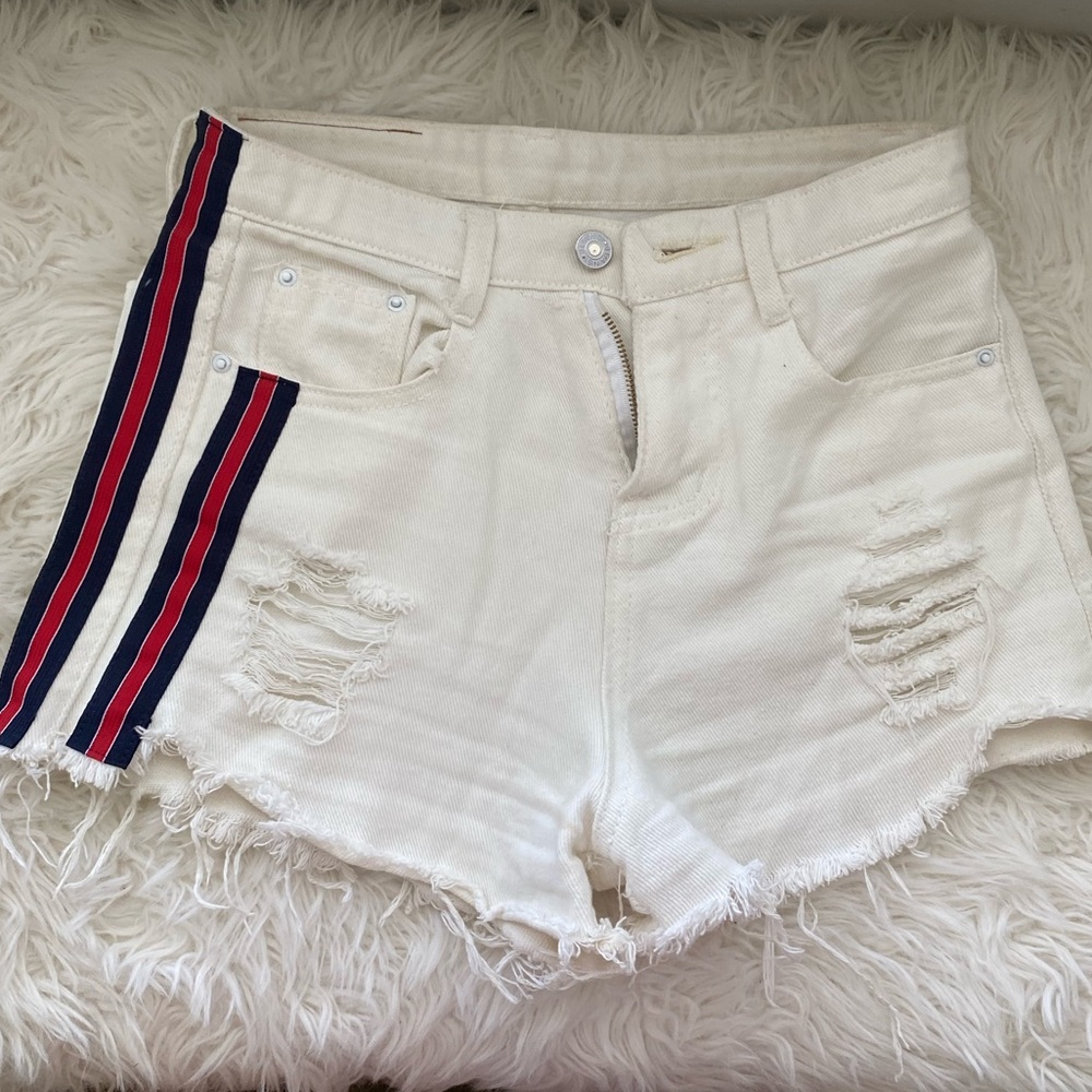 White denim shorts with navy and red side stripes